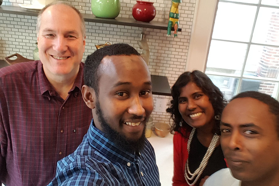 The Rev. Bernie Poppe in the kitchen of St. George's Rectory with (l-r) Jama, Sally Pillay (First Friends Program Director) and Paulos.