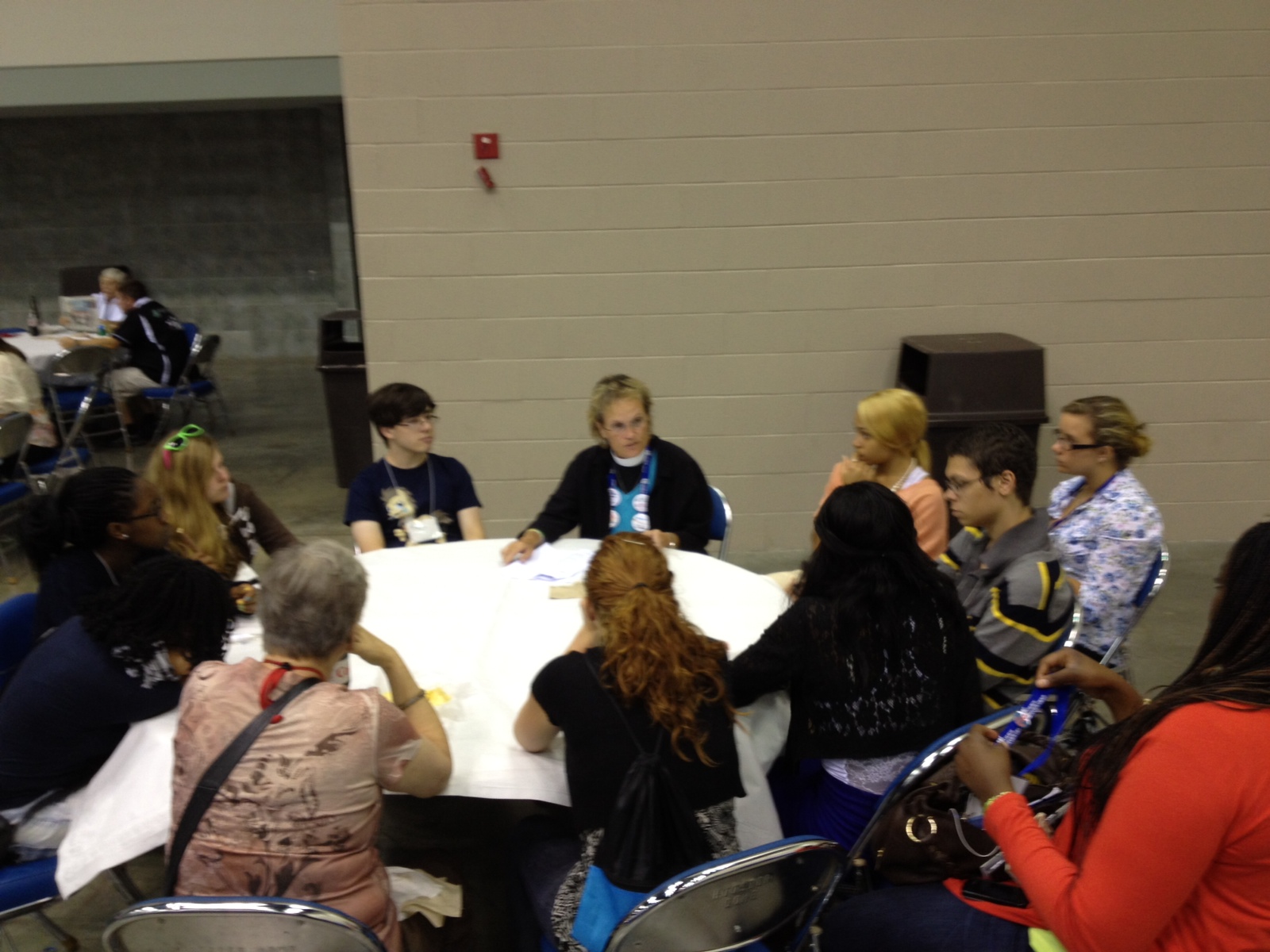Chaplain Diana Wilcox talking with the youth attendees about what they witnessed in the House of Bishops